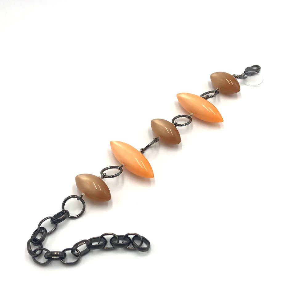 Moonglow pod station bracelet in tangerine & champagne. Vintage 1960s Lucite, adjustable 6.5"-10", hypoallergenic. Stackable, made in USA.