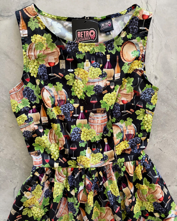 Made in USA. Shop the Wine Vintage Dress by Retrolicious in 100% cotton, with a high neckline, longer full skirt and hidden pockets. Sizes XS–4X.