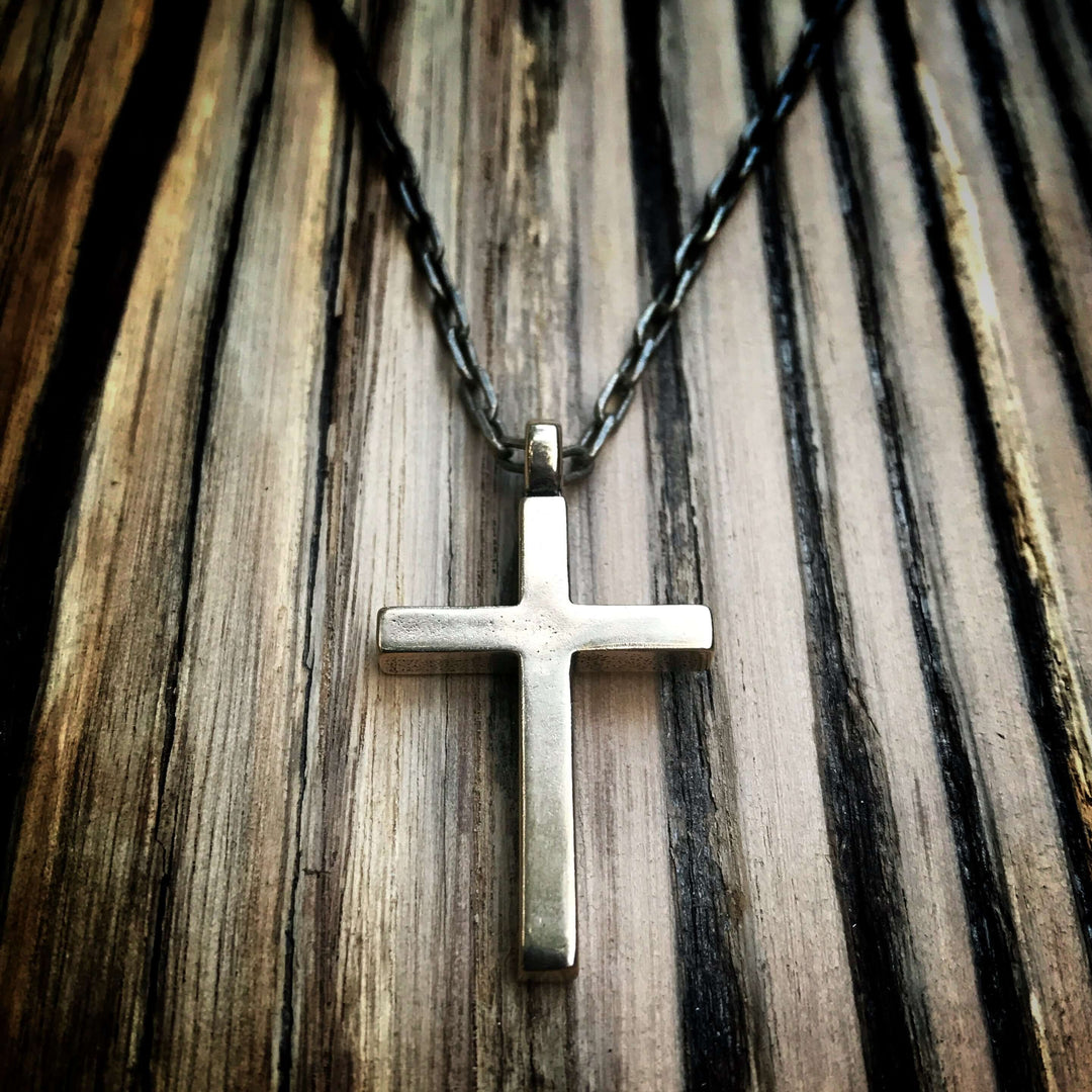 Handcrafted solid bronze cross necklace on an antique bronze chain. Custom lengths available. Made in USA with a lifetime warranty.