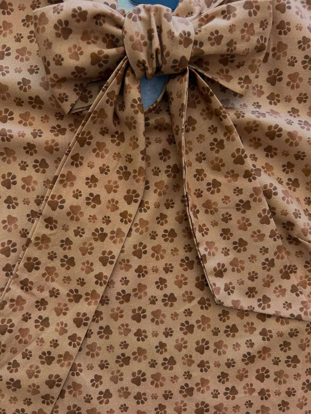 Vintage Style Tops This top is for the vintage lover at heart! Now available in our Paw print. This 100% cotton top features bust darts for a flattering silhouette, a side zippered closure for ease of wear, and an oversized bow at the neckline for that perfect 1950&