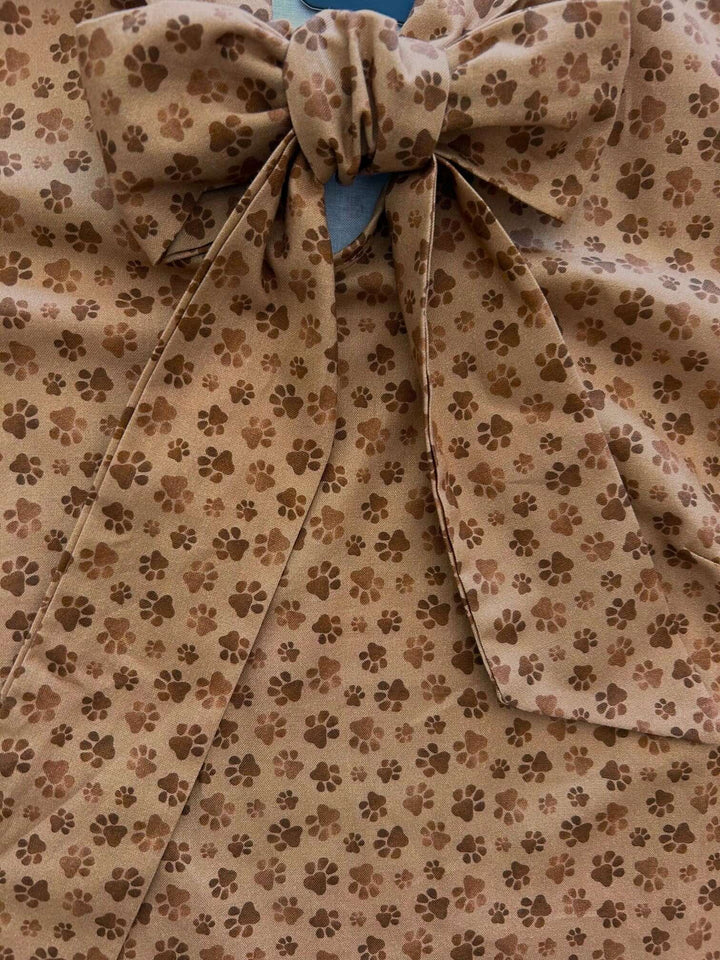 Vintage Style Tops This top is for the vintage lover at heart! Now available in our Paw print. This 100% cotton top features bust darts for a flattering silhouette, a side zippered closure for ease of wear, and an oversized bow at the neckline for that perfect 1950&