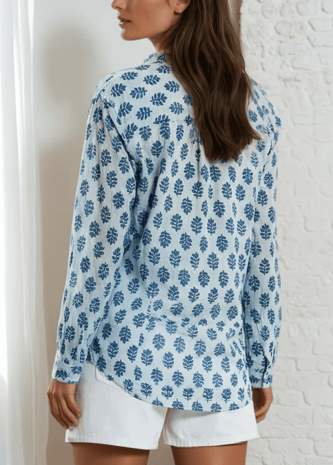 Effortless elegance meets everyday comfort in this Made in USA vintage-washed cotton-voile button-down. Hand-block inspired indigo florals dance across a serene sky-blue canvas, creating a timeless aesthetic that transitions seamlessly from casual to polished. The lightweight, breathable 100% cotton construction keeps you cool and comfortable.