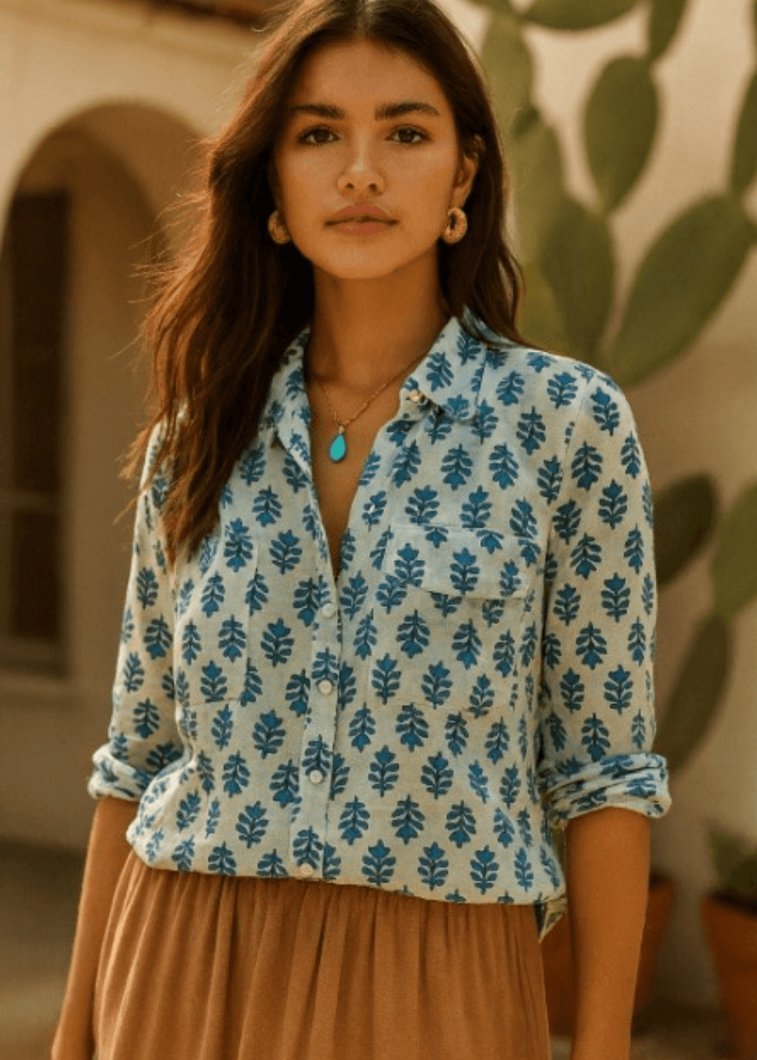 Effortless elegance meets everyday comfort in this Made in USA vintage-washed cotton-voile button-down. Hand-block inspired indigo florals dance across a serene sky-blue canvas, creating a timeless aesthetic that transitions seamlessly from casual to polished. The lightweight, breathable 100% cotton construction keeps you cool and comfortable.