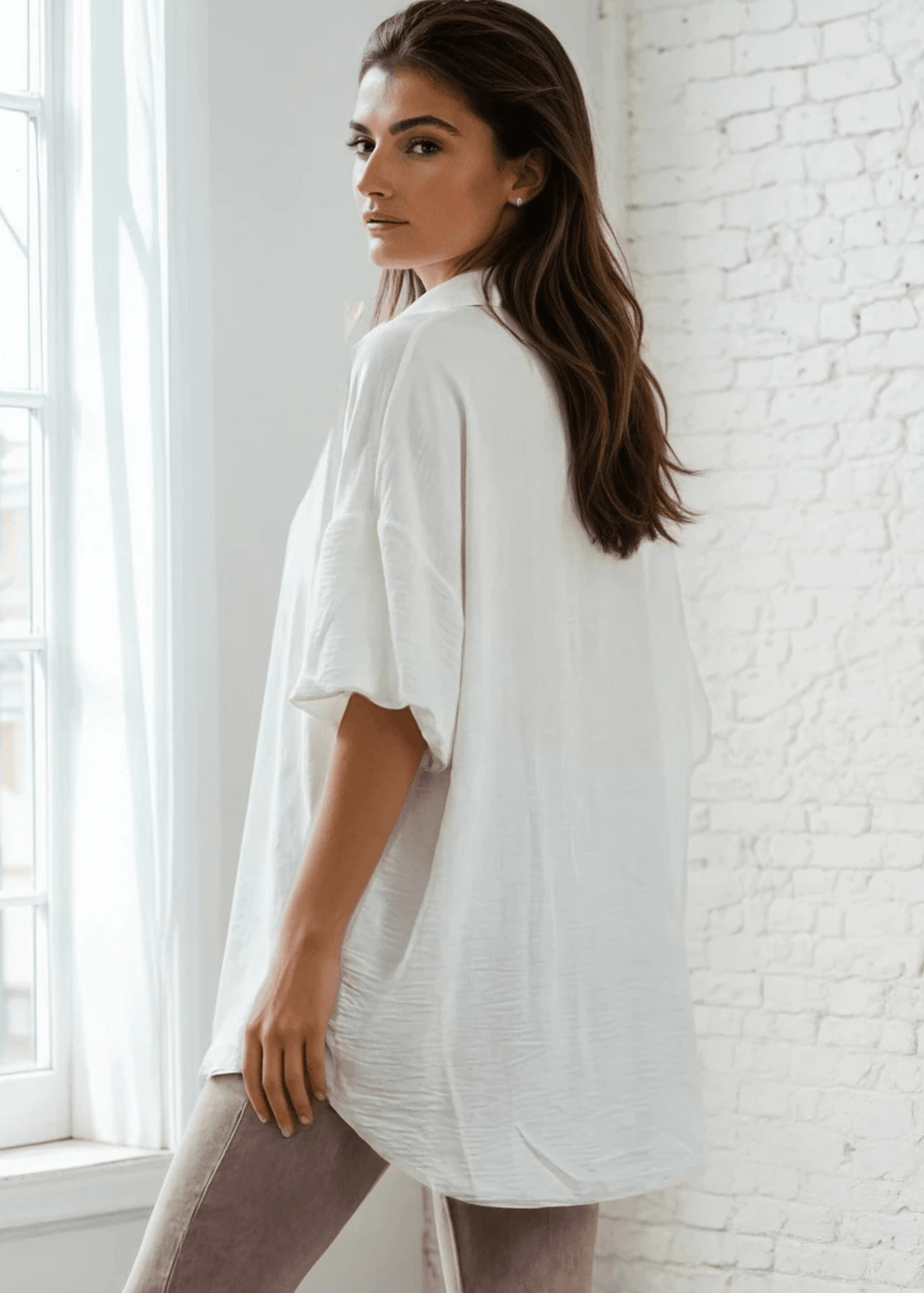 The Julie Oversize Women's Short Sleeve Button Down Shirt in White brings effortless style to your everyday wardrobe. Crafted from a soft, lightweight polyester-spandex blend, this collared button-up features a relaxed oversized fit that works beautifully layered or worn solo. 
