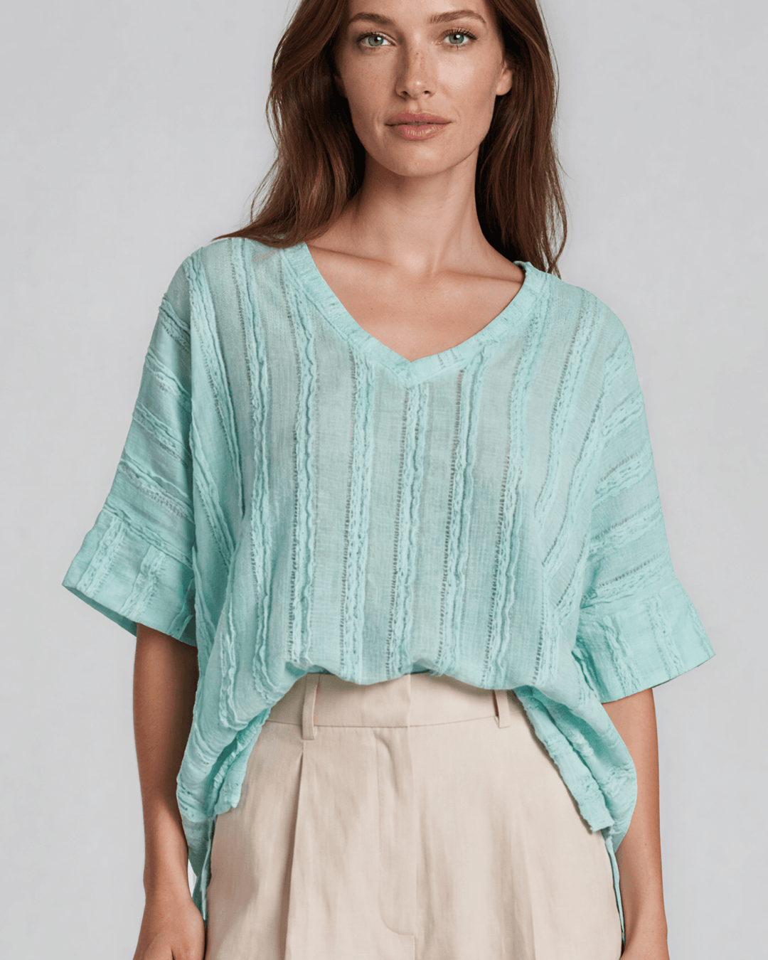 Shop the Laurel Textured Top in Aqua Blue — a relaxed oversized v-neck with striped lace effect, contrast sleeve bands &amp; side slit. Made in USA.