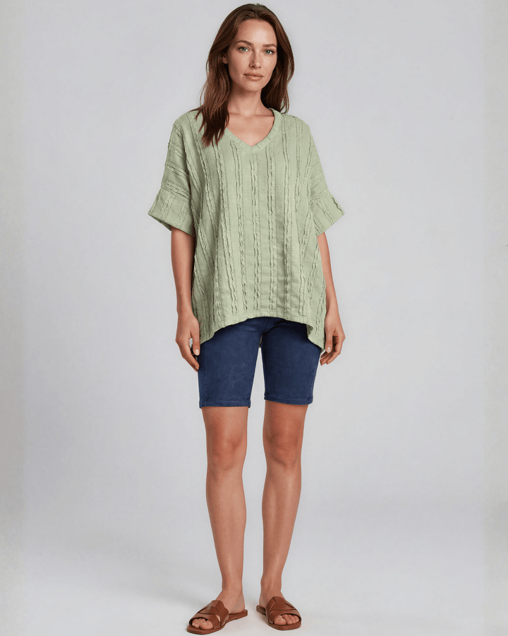 Shop the Laurel Textured Top in Light Sage — a relaxed oversized v-neck with striped lace effect, contrast sleeve bands &amp; side slit. Made in USA.