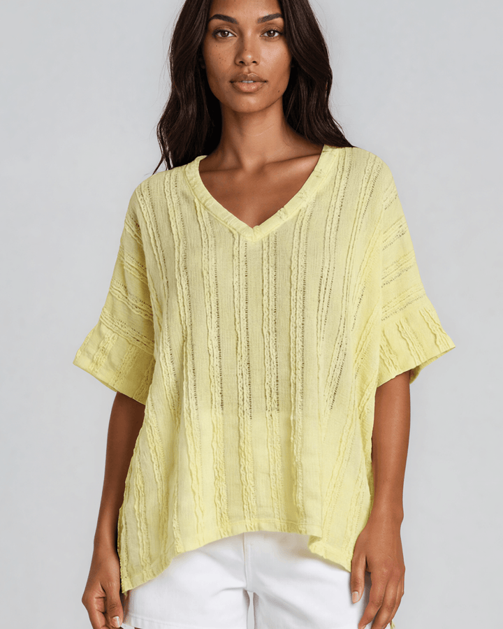 Shop the Laurel Textured Top in Yellow — a relaxed oversized v-neck with striped lace effect, contrast sleeve bands &amp; side slit. Made in USA.