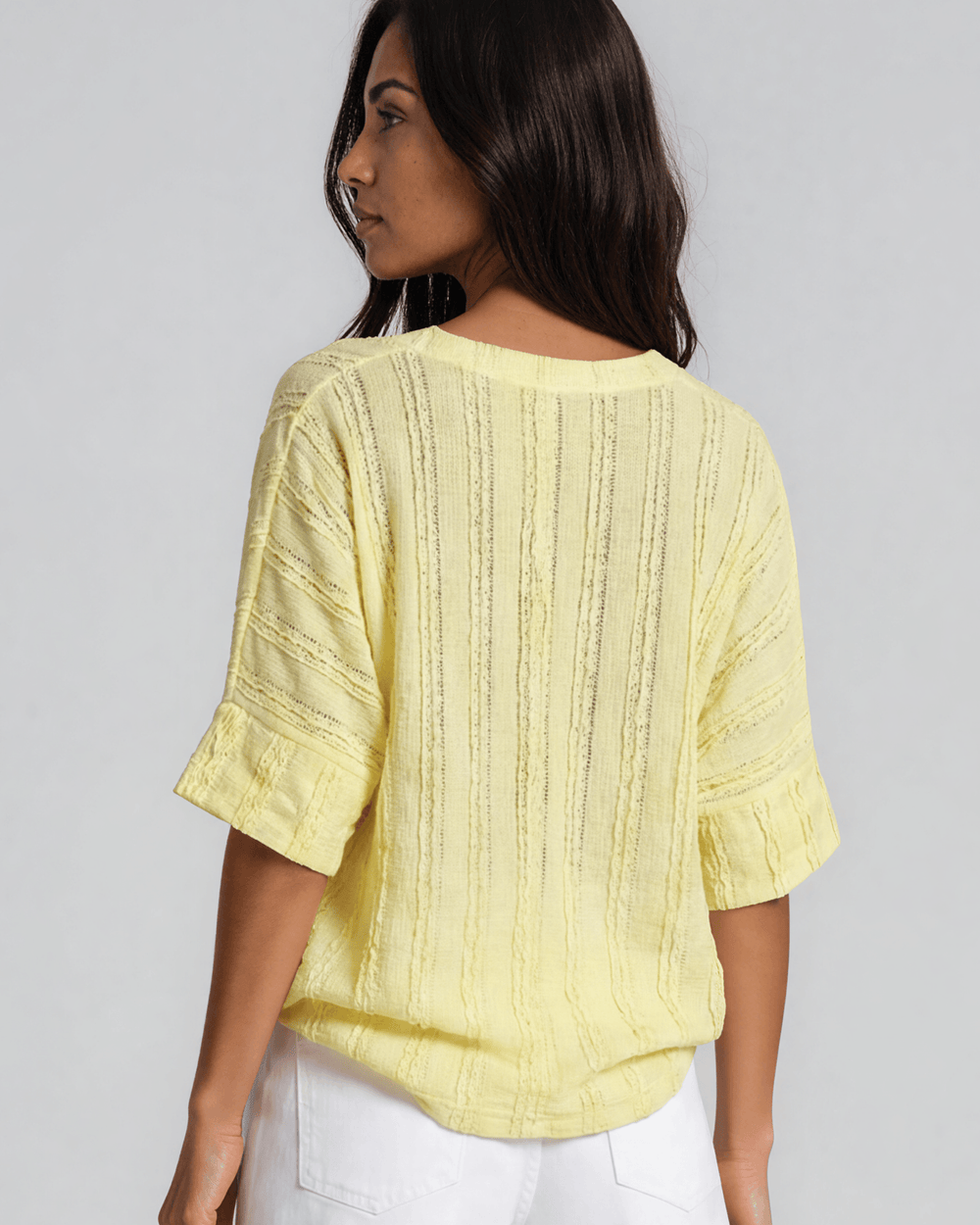 Shop the Laurel Textured Top in Yellow — a relaxed oversized v-neck with striped lace effect, contrast sleeve bands & side slit. Made in USA.
