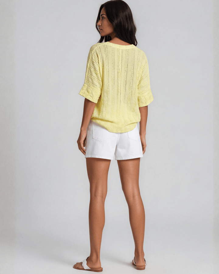 Shop the Laurel Textured Top in Yellow — a relaxed oversized v-neck with striped lace effect, contrast sleeve bands &amp; side slit. Made in USA.