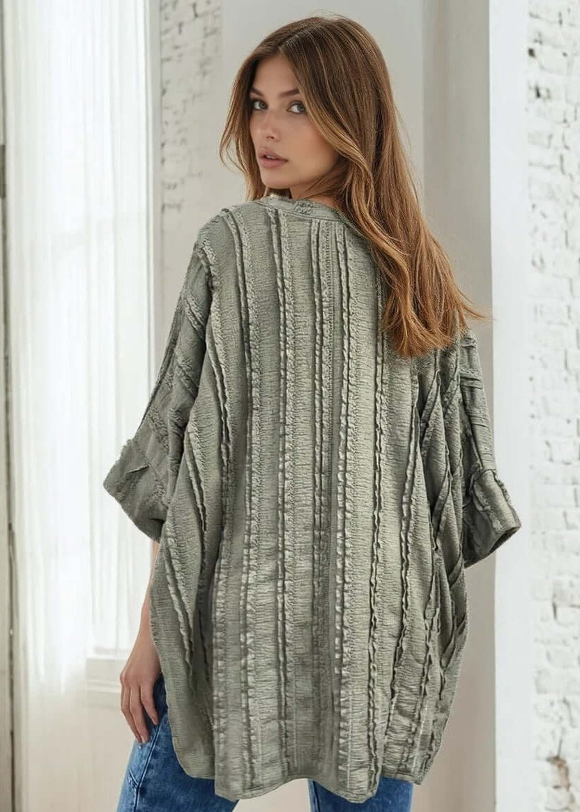 Elevate your everyday wardrobe with the Laurel Textured Top in Off White or Sage Green, a versatile Made in USA essential. This textured oversized v-neck features a delicate striped lace effect and half sleeves contrasting bands for a polished look. 
