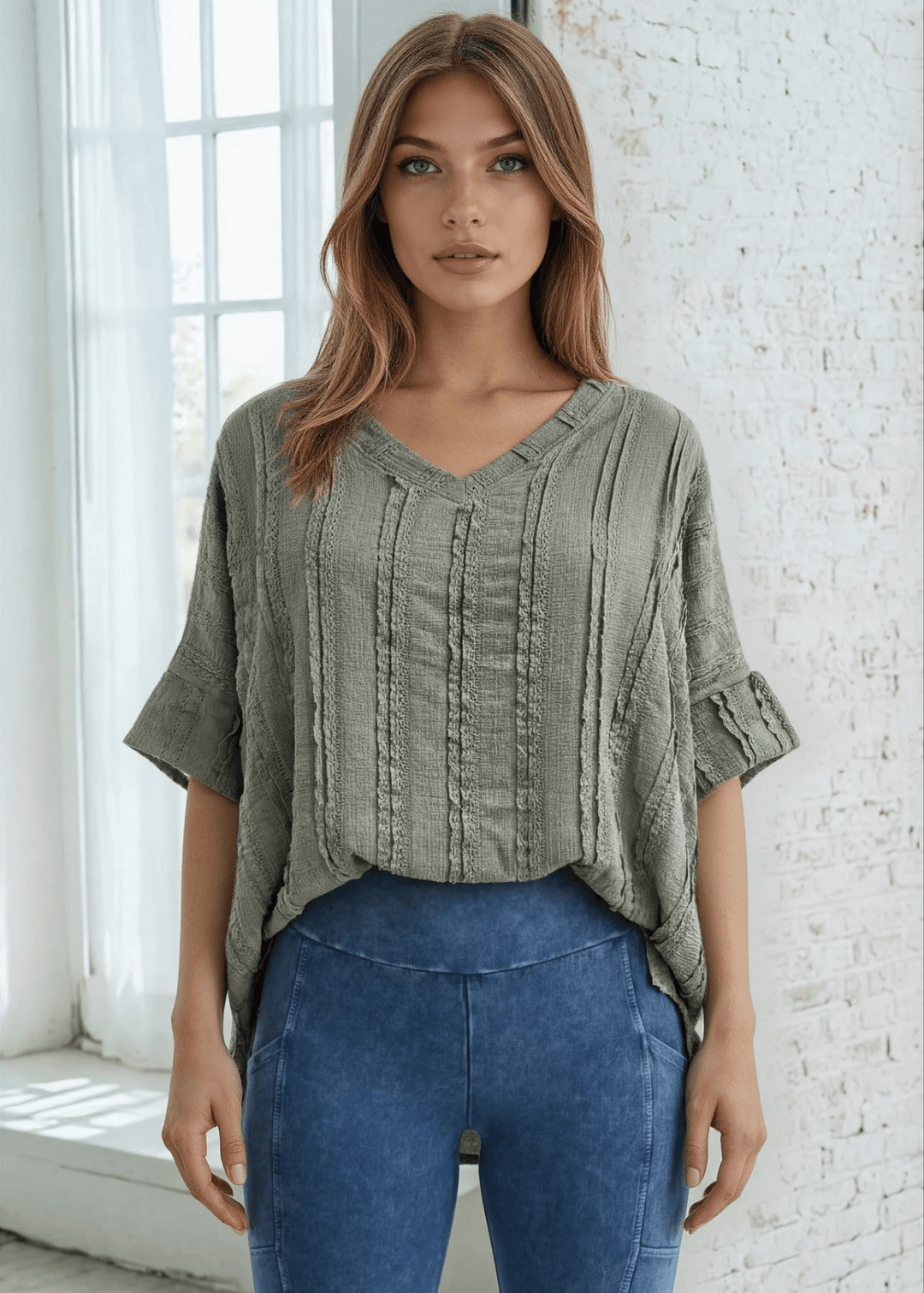 Elevate your everyday wardrobe with the Laurel Textured Top in Off White or Sage Green, a versatile Made in USA essential. This textured oversized v-neck features a delicate striped lace effect and half sleeves contrasting bands for a polished look. 