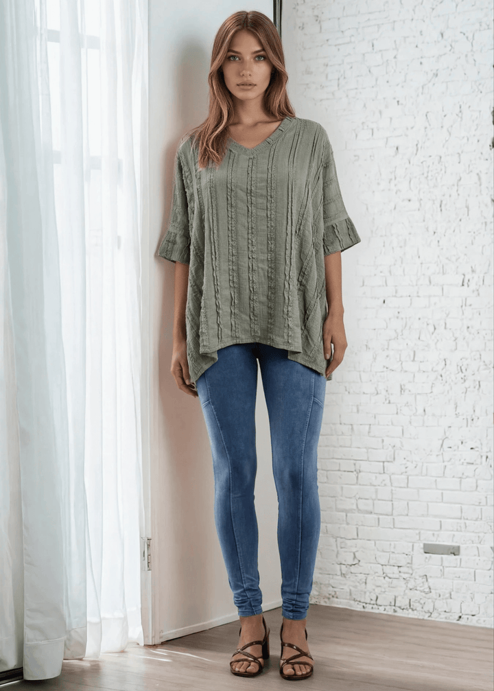 Elevate your everyday wardrobe with the Laurel Textured Top in Off White or Sage Green, a versatile Made in USA essential. This textured oversized v-neck features a delicate striped lace effect and half sleeves contrasting bands for a polished look. 