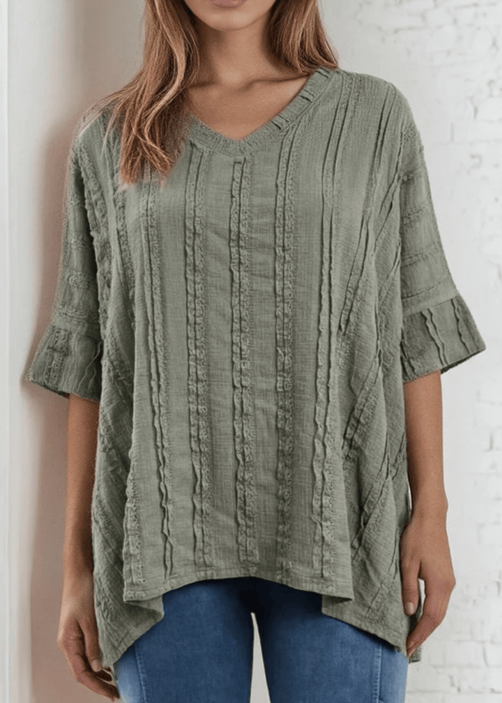 Elevate your everyday wardrobe with the Laurel Textured Top in Off White or Sage Green, a versatile Made in USA essential. This textured oversized v-neck features a delicate striped lace effect and half sleeves contrasting bands for a polished look. 