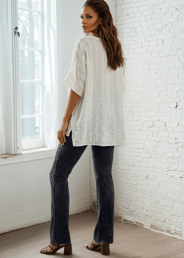 Elevate your everyday wardrobe with the Laurel Textured Top in Off White or Sage Green, a versatile Made in USA essential. This textured oversized v-neck features a delicate striped lace effect and half sleeves contrasting bands for a polished look. 