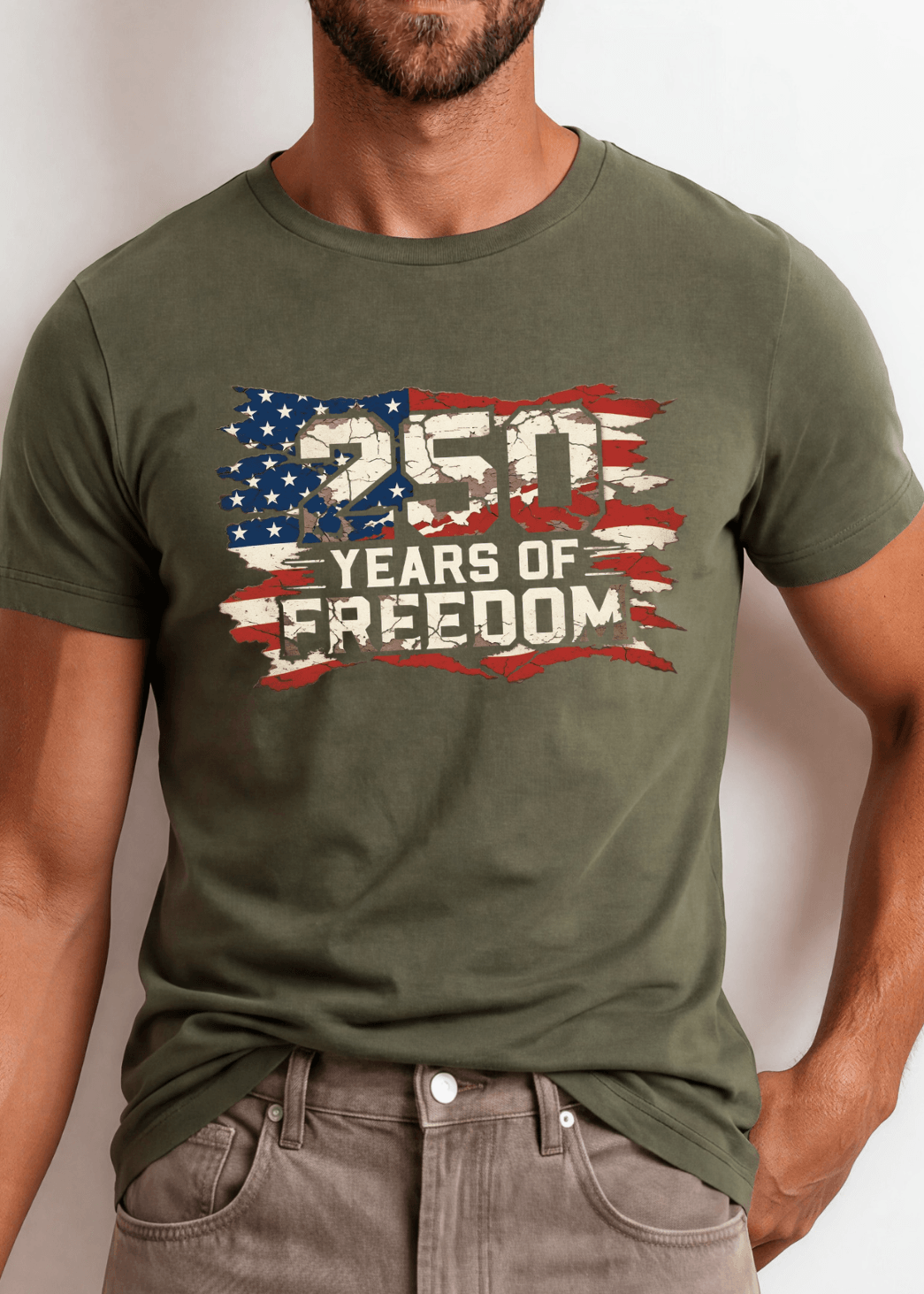 250 Years of Freedom Distressed Flag Tee — Made in USA. Bold cracked flag graphic on Army Green, soft 100% cotton, relaxed fit. Perfect for 4th of July. Sizes S-2XL.