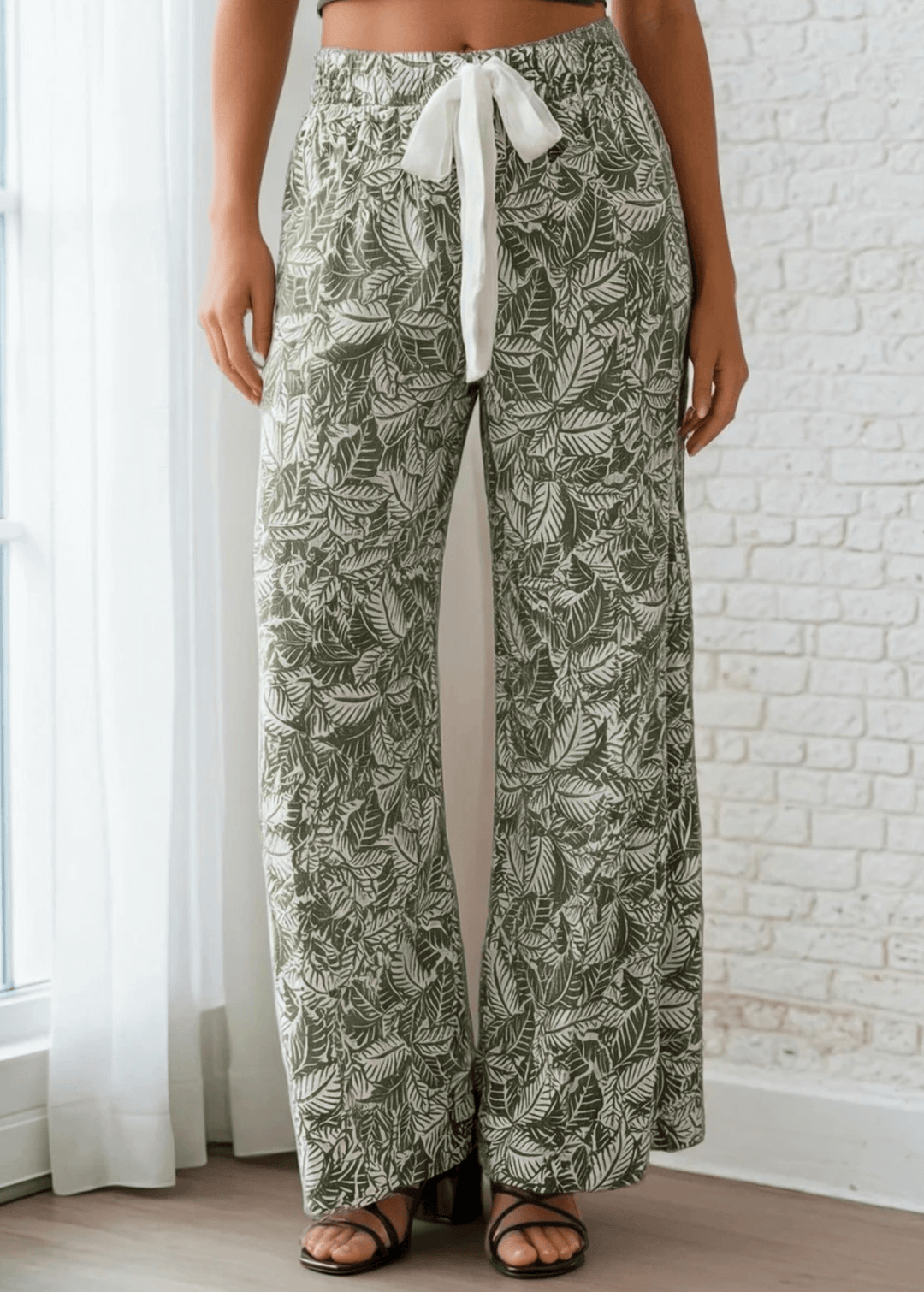 Elevate your casual wardrobe with these Made in USA Women's Soft Floral Pants, featuring a striking tiered leaf print in olive and off-white. Designed for all-day comfort, they boast a super soft ribbed fabric that's lightweight and breathable. 