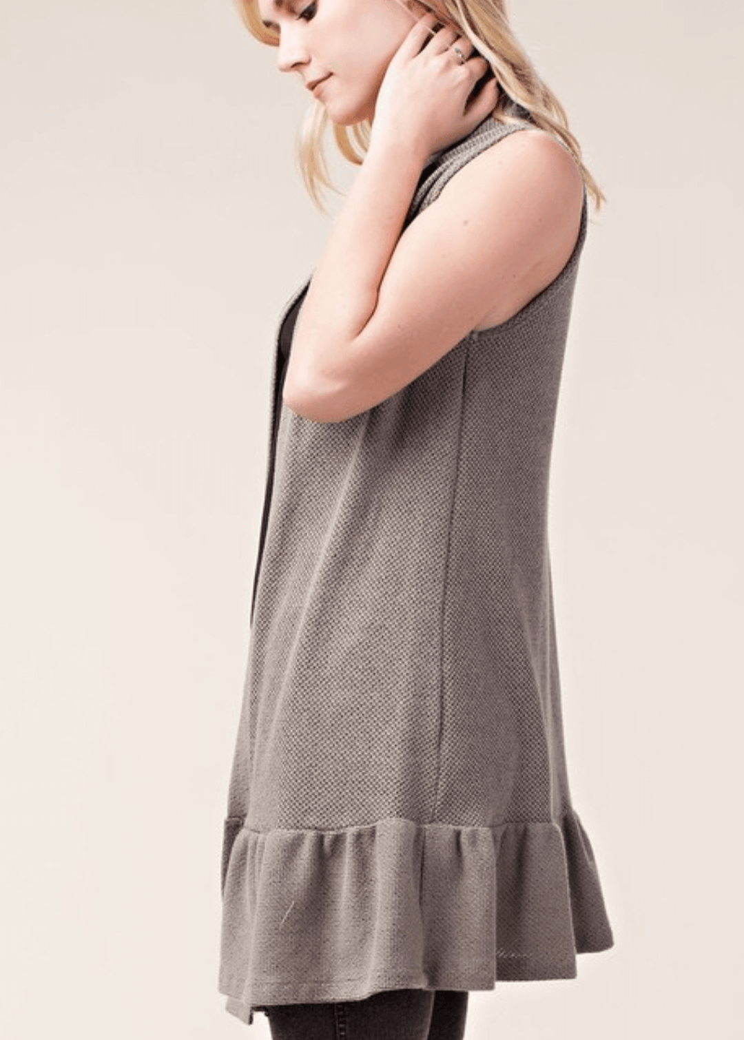 The Monica Open Front Ruffled Knit Accent Vest is your go-to layering piece for effortless style. This sleeveless cardigan vest features a charming flounce ruffle hem that adds movement and dimension to any outfit. 