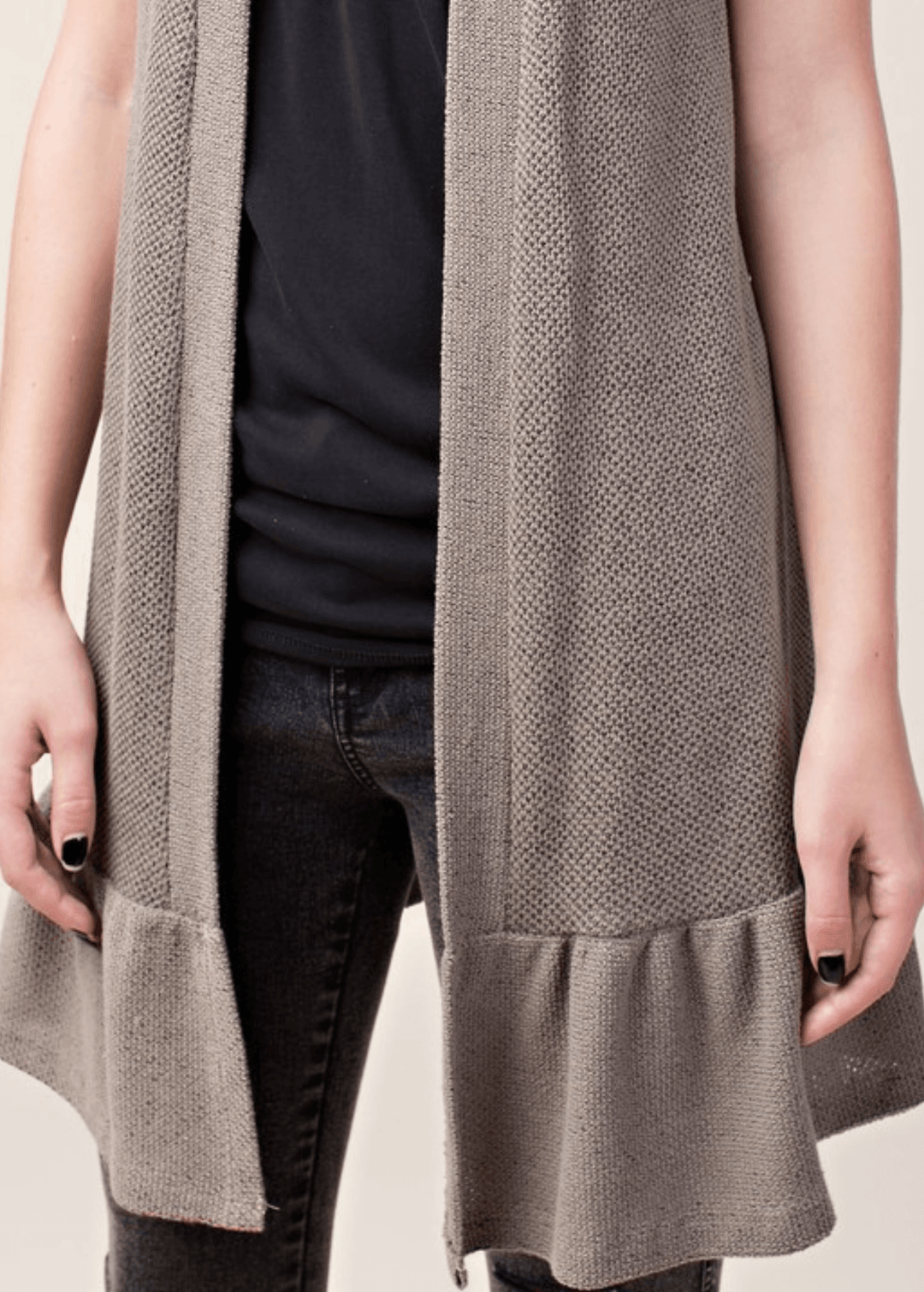The Monica Open Front Ruffled Knit Accent Vest is your go-to layering piece for effortless style. This sleeveless cardigan vest features a charming flounce ruffle hem that adds movement and dimension to any outfit. 