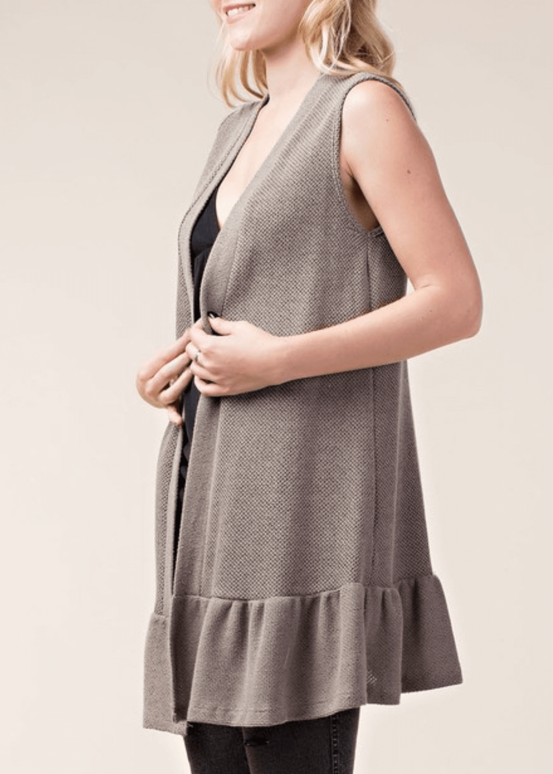 The Monica Open Front Ruffled Knit Accent Vest is your go-to layering piece for effortless style. This sleeveless cardigan vest features a charming flounce ruffle hem that adds movement and dimension to any outfit. 