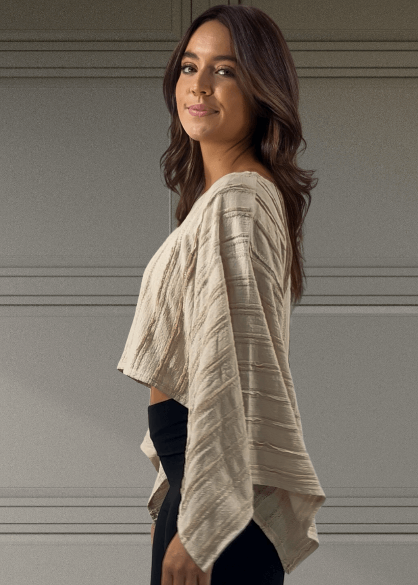 Embrace effortless style with this Kimono Sleeve Cropped Top in a soft beige hue. Featuring a round neck and breezy 3/4 kimono sleeves, its oversized, flowy fit pairs perfectly with the cropped length for a playful, modern look. 