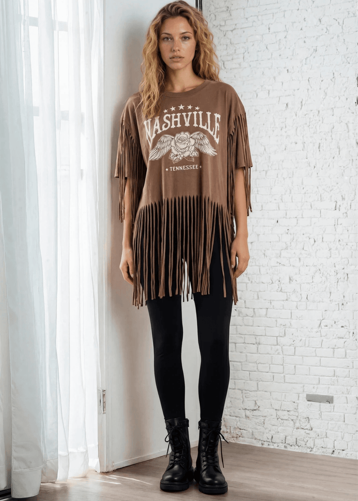 The Farrah Fringe Nashville Top brings effortless style to your everyday wardrobe. Featuring playful fringe detailing and a relaxed silhouette, this versatile piece pairs beautifully with jeans, leggings, or your favorite bottoms. The soft cotton-blend fabric with a touch of spandex offers comfort and gentle stretch, while the round neckline and short sleeves keep things casual and chic. Perfect for layering or wearing solo, this made-in-USA top is a wardrobe essential that works from season to season. 
