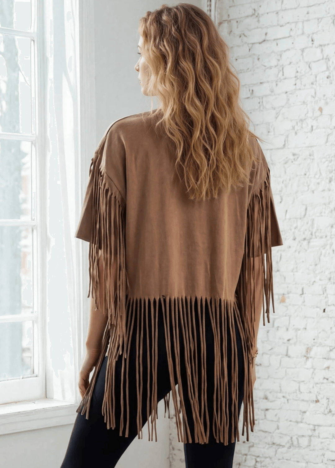 The Farrah Fringe Nashville Top brings effortless style to your everyday wardrobe. Featuring playful fringe detailing and a relaxed silhouette, this versatile piece pairs beautifully with jeans, leggings, or your favorite bottoms. The soft cotton-blend fabric with a touch of spandex offers comfort and gentle stretch, while the round neckline and short sleeves keep things casual and chic. Perfect for layering or wearing solo, this made-in-USA top is a wardrobe essential that works from season to season. 