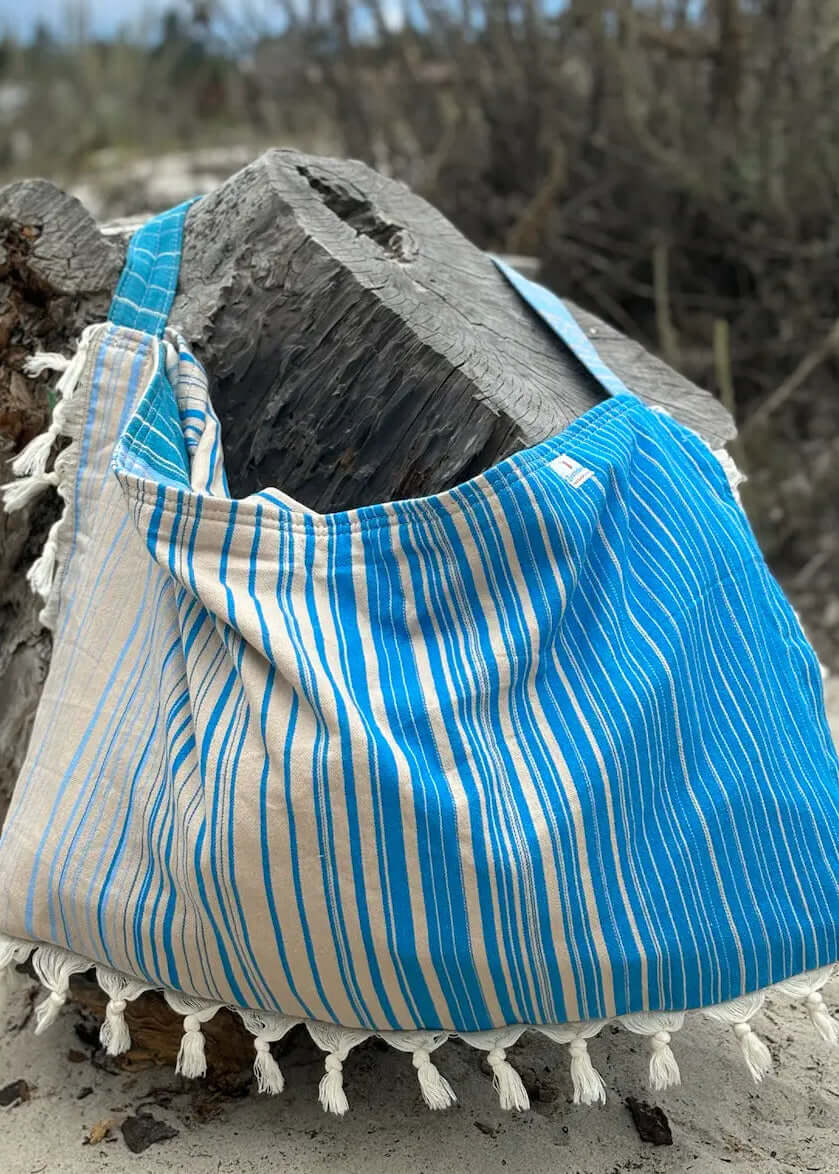 Shop the Beachables Striped 3-in-1 Turkish Cotton Beach Bag – converts from bag to towel to chair cover. Sand-resistant, quick-dry, machine washable. Made in USA.
