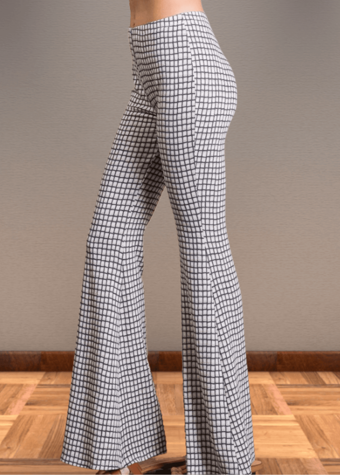 Step up your style game with these Jersey Plaid Skinny Flares, designed to flatter every curve with their mid-rise, slim-fit cut that elegantly flares at the ankle. Made from a luxuriously soft jersey fabric blend, they offer unbeatable comfort and stretch for all-day wear. The timeless black and off-white plaid pattern adds a bold yet classic touch, making these pants perfect for turning heads whether at the office or out on the town. Bucket List Style P5009D