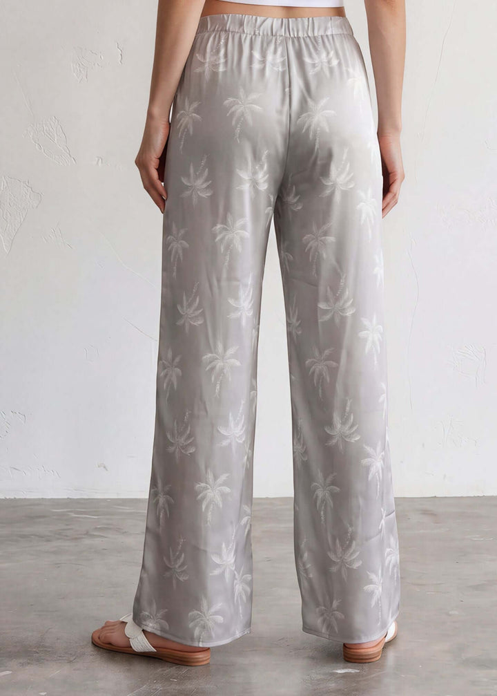  Presley Palm Tree Wide Leg Pants — a relaxed wide-leg style with a tonal palm print, elastic waist &amp; drawstring. Made in USA. Perfect for resort &amp; vacation.