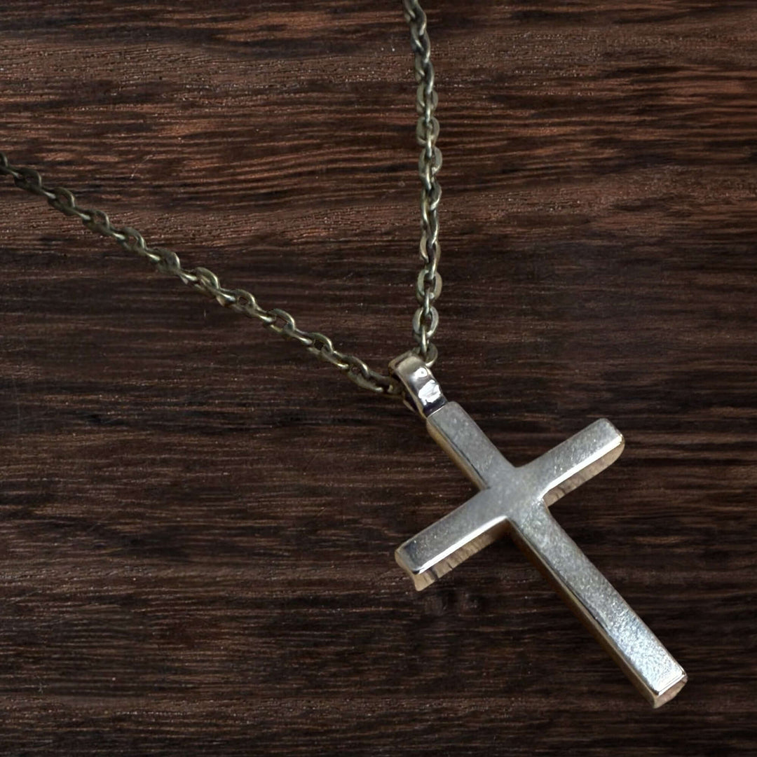 Handcrafted solid bronze cross necklace on an antique bronze chain. Custom lengths available. Made in USA with a lifetime warranty.