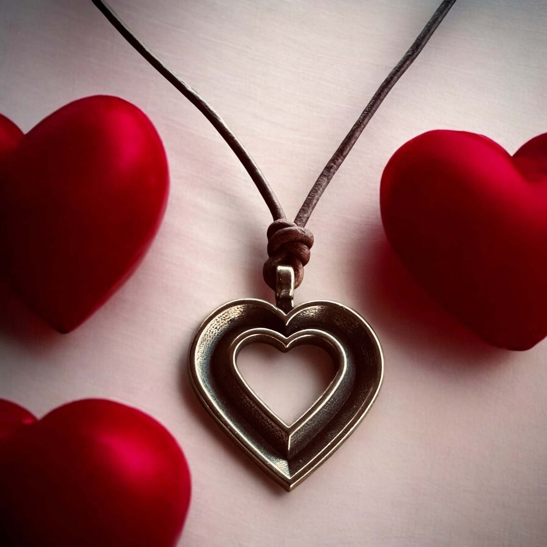Handcrafted solid bronze LOVE heartbeat necklace on an adjustable leather cord. Made in USA with a lifetime warranty