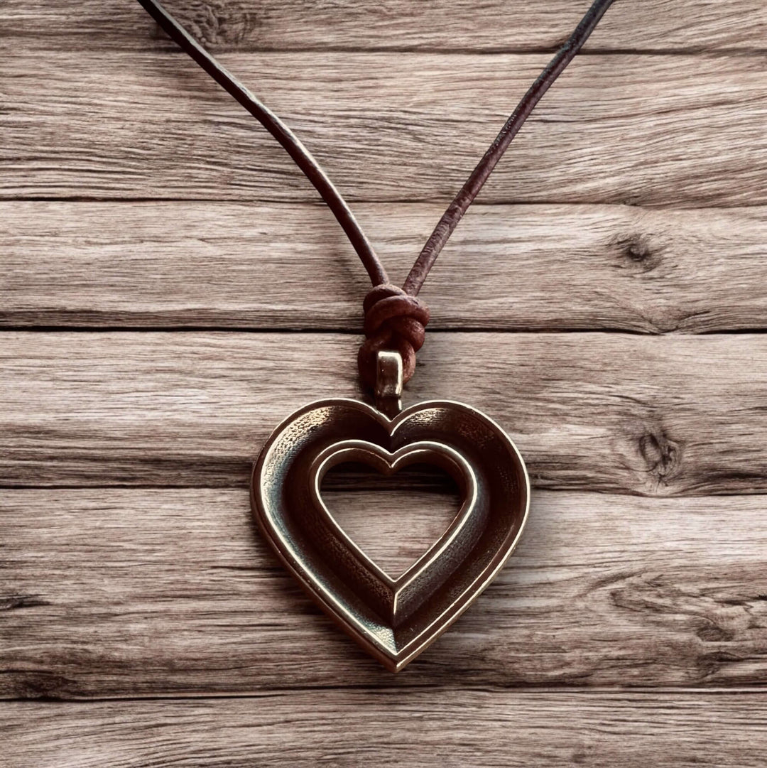 Handcrafted solid bronze LOVE heartbeat necklace on an adjustable leather cord. Made in USA with a lifetime warranty