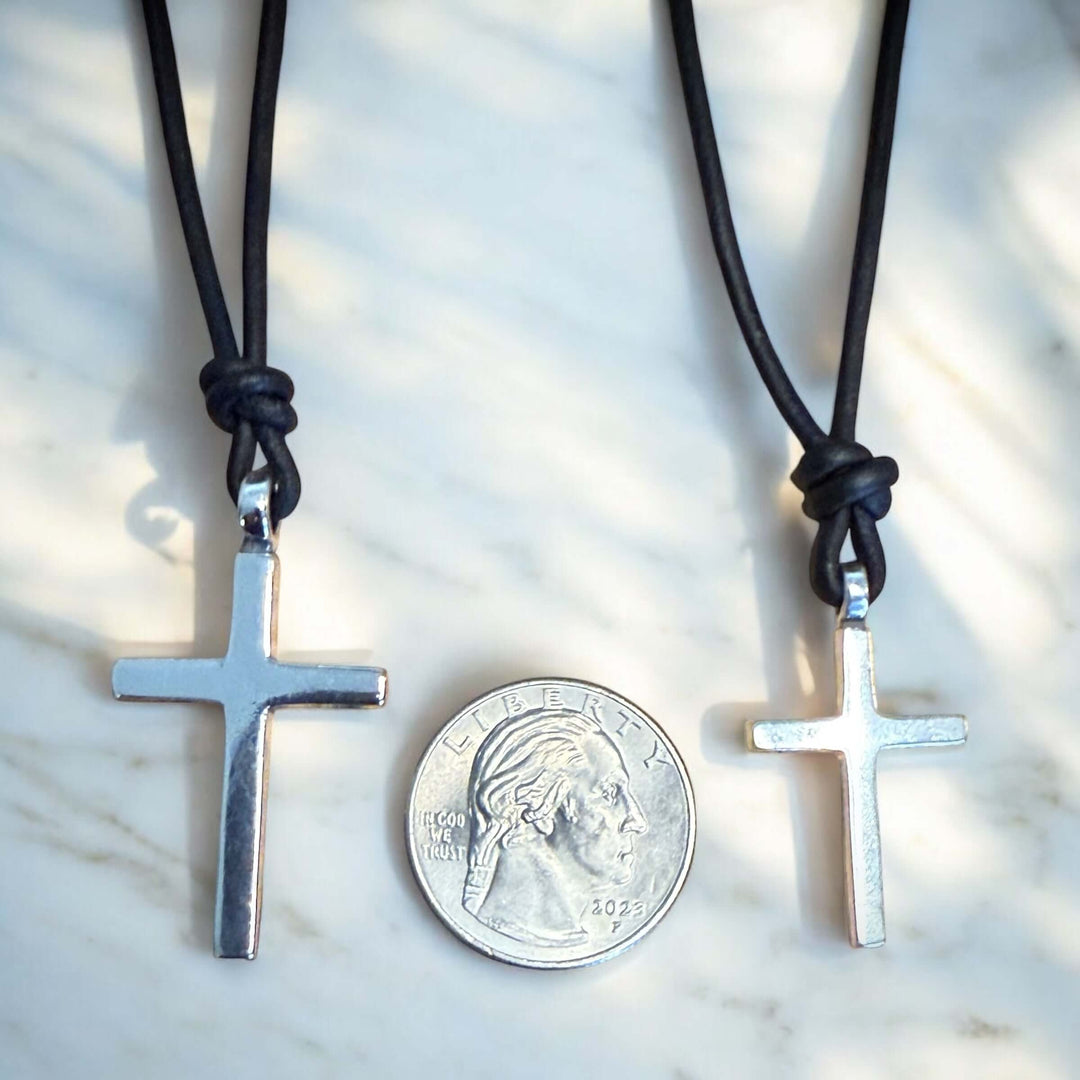 Handcrafted solid sterling silver cross on an adjustable leather cord. Unisex. Available in black, dark brown, or red brown. Made in USA