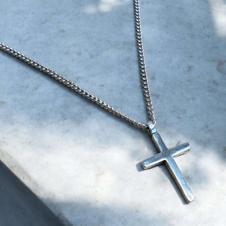 Handcrafted solid sterling silver cross necklace on a stainless steel chain. Custom lengths available. Made in USA with a lifetime warranty. 