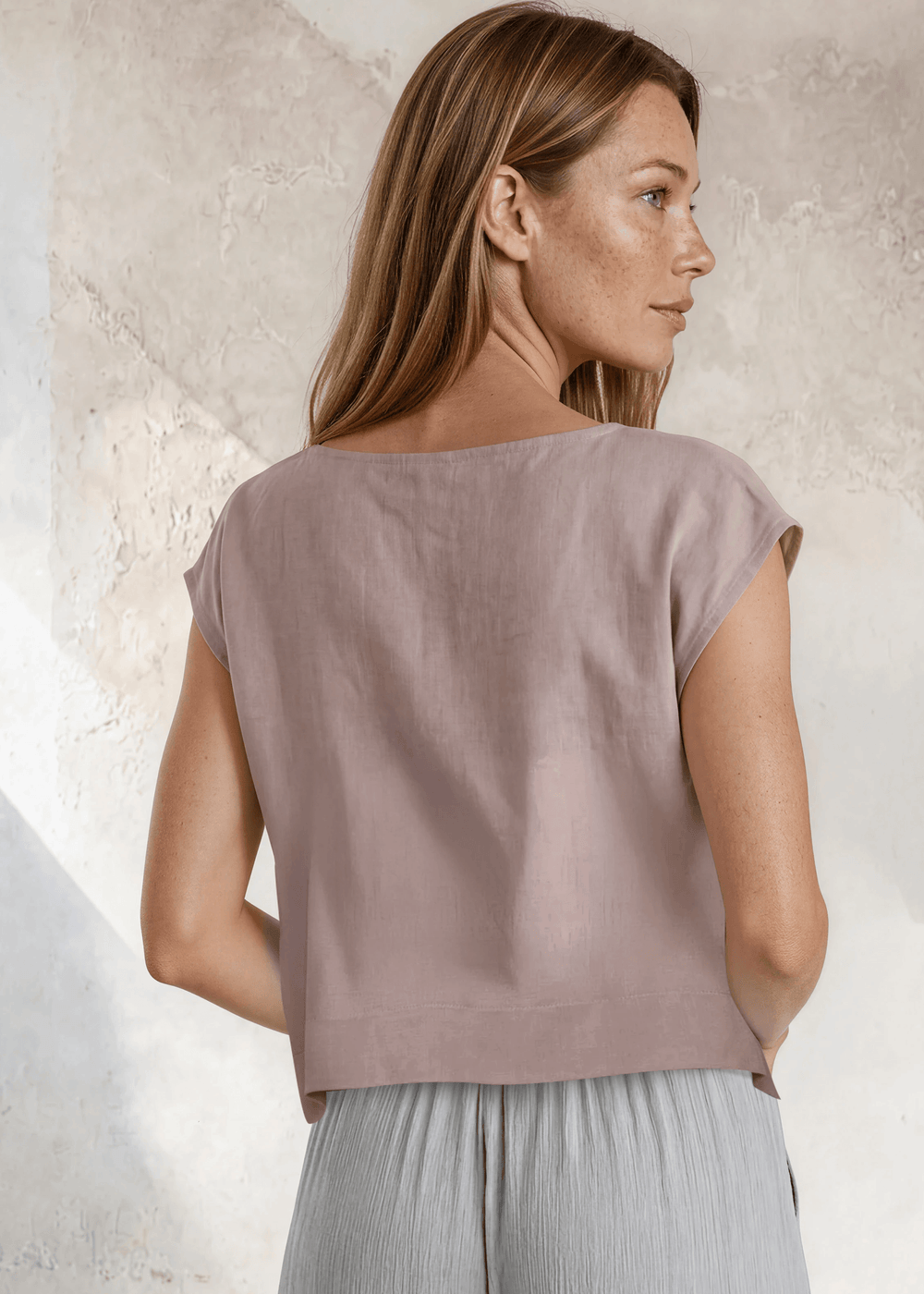 Shop the Bella Boxy Top in Rose Quartz — a lightweight 100% rayon crosshatch woven top with a relaxed fit and cap sleeves. Made in USA. True to size.