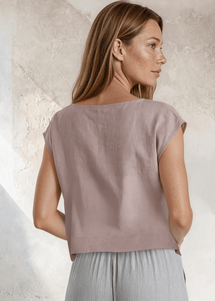 Shop the Bella Boxy Top in Rose Quartz — a lightweight 100% rayon crosshatch woven top with a relaxed fit and cap sleeves. Made in USA. True to size.