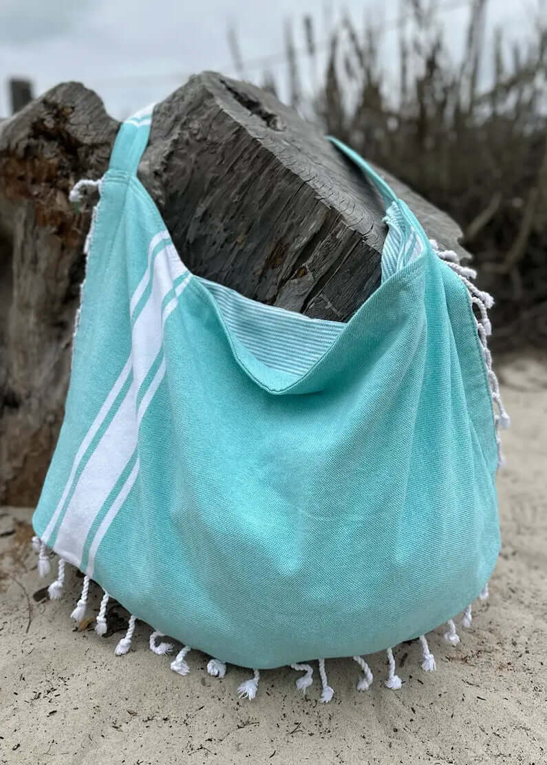 Shop the Beachables Solid 3-in-1 Turkish Cotton Beach Bag – converts from bag to towel to chair cover. Sand-resistant, quick-dry, machine washable. Made in USA.