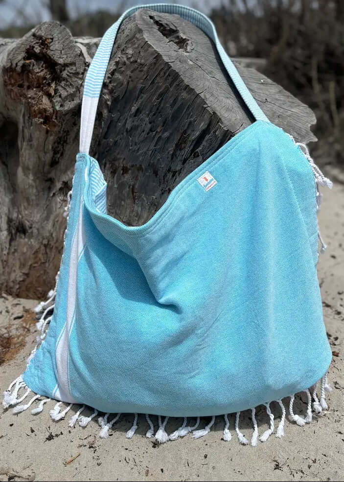 Shop the Beachables Solid 3-in-1 Turkish Cotton Beach Bag – converts from bag to towel to chair cover. Sand-resistant, quick-dry, machine washable. Made in USA.