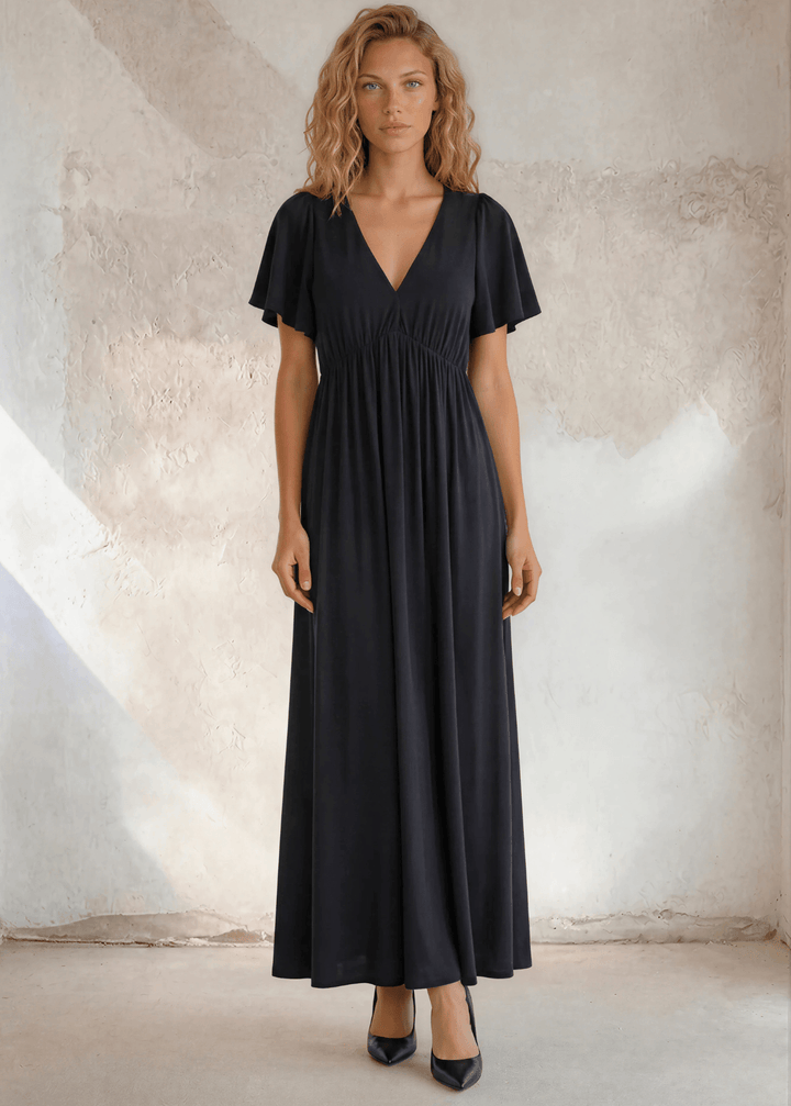 The little black maxi dress you’ve been looking for — deep V-neck, flutter sleeves, flowing empire waist. Effortlessly elegant. USA-made.