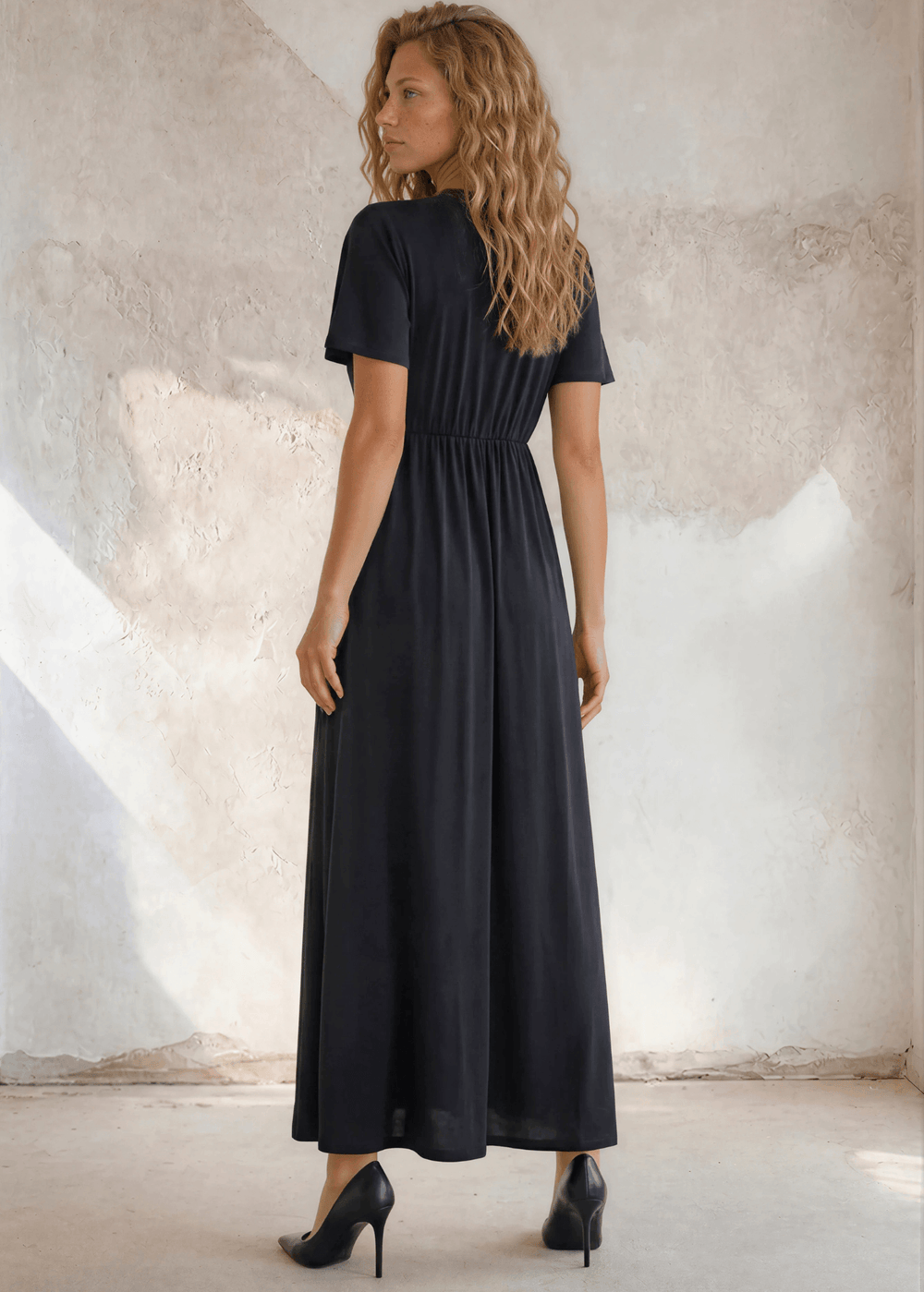 The little black maxi dress you’ve been looking for — deep V-neck, flutter sleeves, flowing empire waist. Effortlessly elegant. USA-made.