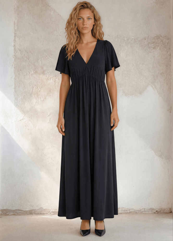 The little black maxi dress you’ve been looking for — deep V-neck, flutter sleeves, flowing empire waist. Effortlessly elegant. USA-made.