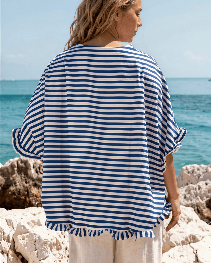 Effortlessly chic blue &amp; white striped oversized top with ruffle cuffs &amp; button-up front. Lightweight, flowy fit perfect for spring &amp; summer. Made in USA.