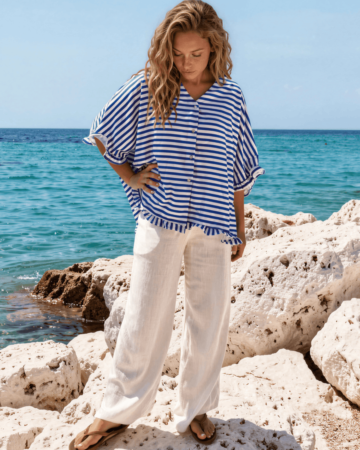 Effortlessly chic blue &amp; white striped oversized top with ruffle cuffs &amp; button-up front. Lightweight, flowy fit perfect for spring &amp; summer. Made in USA.