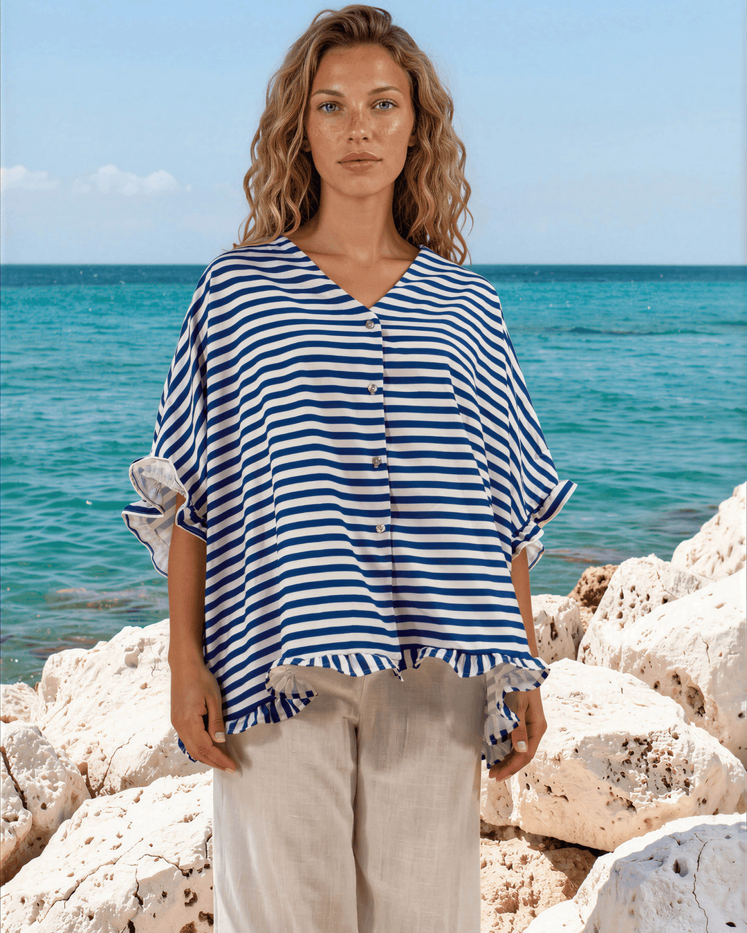 Effortlessly chic blue &amp; white striped oversized top with ruffle cuffs &amp; button-up front. Lightweight, flowy fit perfect for spring &amp; summer. Made in USA.