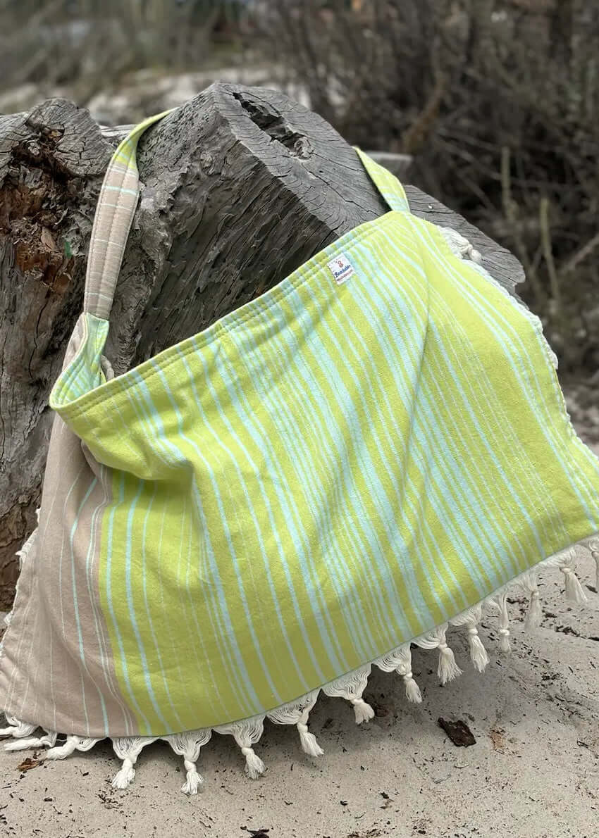 Shop the Beachables Striped 3-in-1 Turkish Cotton Beach Bag – converts from bag to towel to chair cover. Sand-resistant, quick-dry, machine washable. Made in USA.