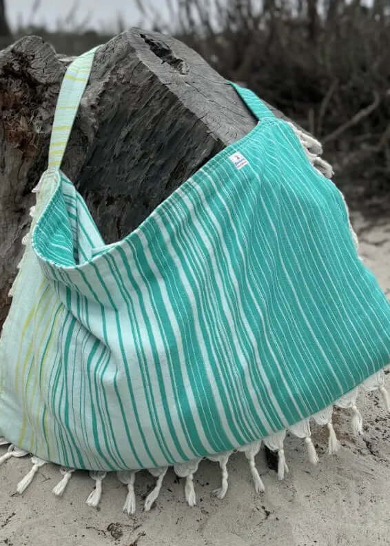 Shop the Beachables Striped 3-in-1 Turkish Cotton Beach Bag – converts from bag to towel to chair cover. Sand-resistant, quick-dry, machine washable. Made in USA.