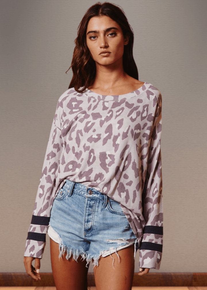 Experience effortless style with the Dusty Lavender Animal Print Top. Its wide round neckline and relaxed fit provide comfort without compromising on fashion.  Bucket List Style T1100
