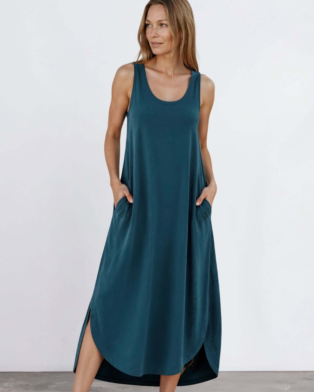 Shop the Sammie Sleeveless Maxi Dress in teal. Relaxed fit, scoop neck, side pockets & slits. 95% Rayon, 5% Spandex. Made in USA. Free shipping may apply.