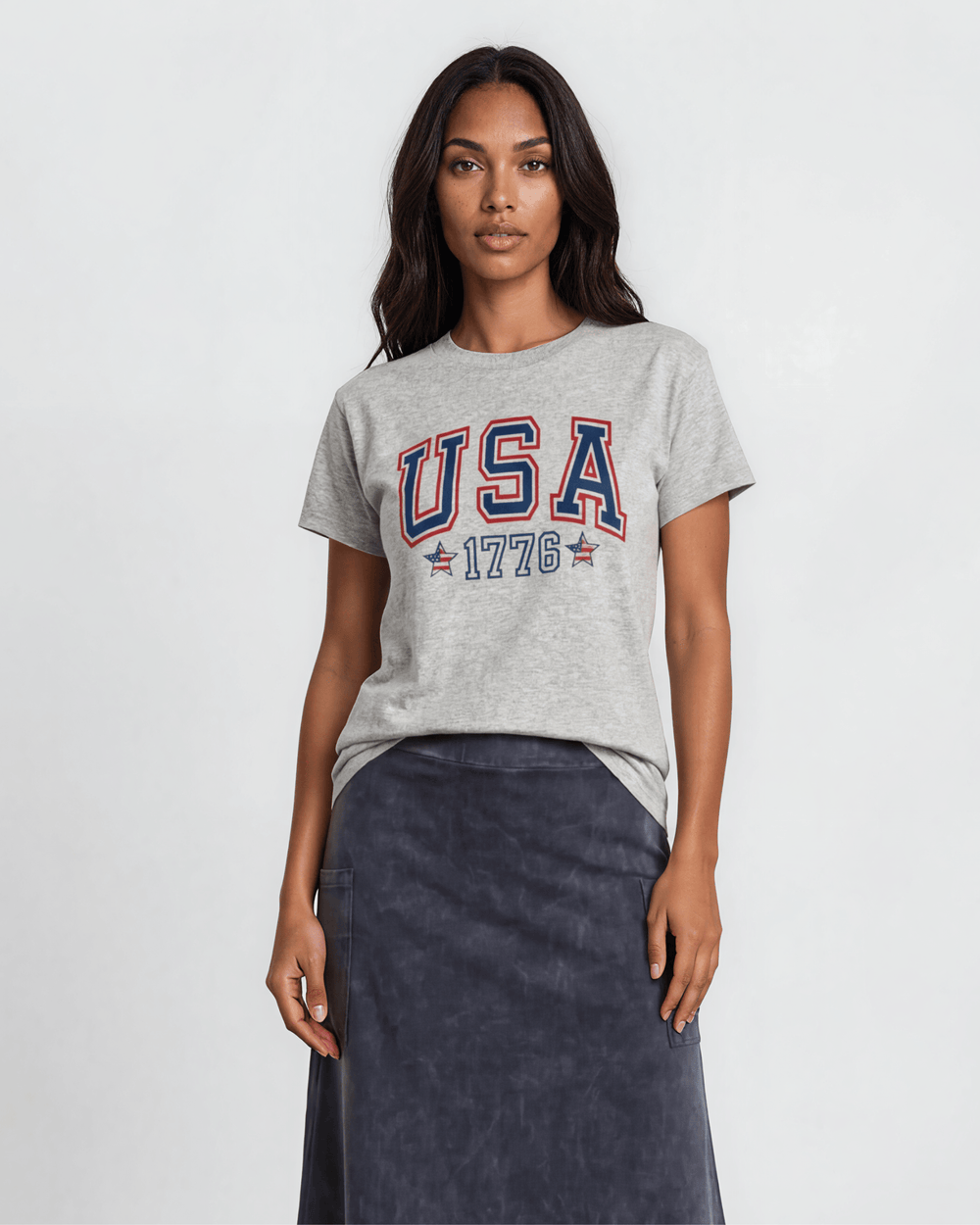 Women's USA 1776 collegiate graphic tee made in USA. Bold navy & red lettering with flag stars on heather gray 100% cotton. Relaxed fit, XS-3X. Perfect for 4th of July.