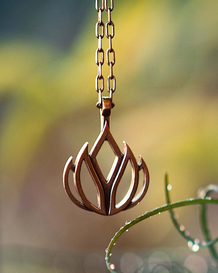 Handcrafted solid bronze lotus flower necklace on an 18 or 24 inch antique bronze chain. Made in USA with a lifetime warranty.